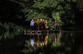 Monks come to offer alms by coming through the water by punting on bamboo rafts along the river at O Ã¢â¬â¹Ã¢â¬â¹Poi Market